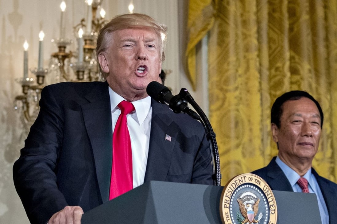 U.S. President Donald Trump speaks as billionaire Terry Gou, chairman of Foxconn Technology Group, right, listens during an event in the East Room of the White House in Washington, D.C., U.S., on Wednesday, July 26, 2017. Trump announced that Foxconn Technology Group plans a new factory in Wisconsin, fulfilling the Taiwanese manufacturing giants promise to invest in the U.S. Photographer: Andrew Harrer/Bloomberg