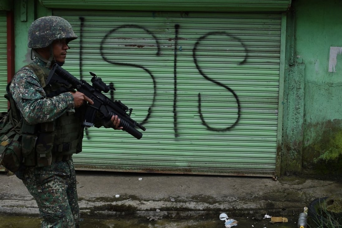 A Philippine marine on patrol along a street in Marawi, Mindanao, where government forces are fighting Islamist militants. Photo: AFP