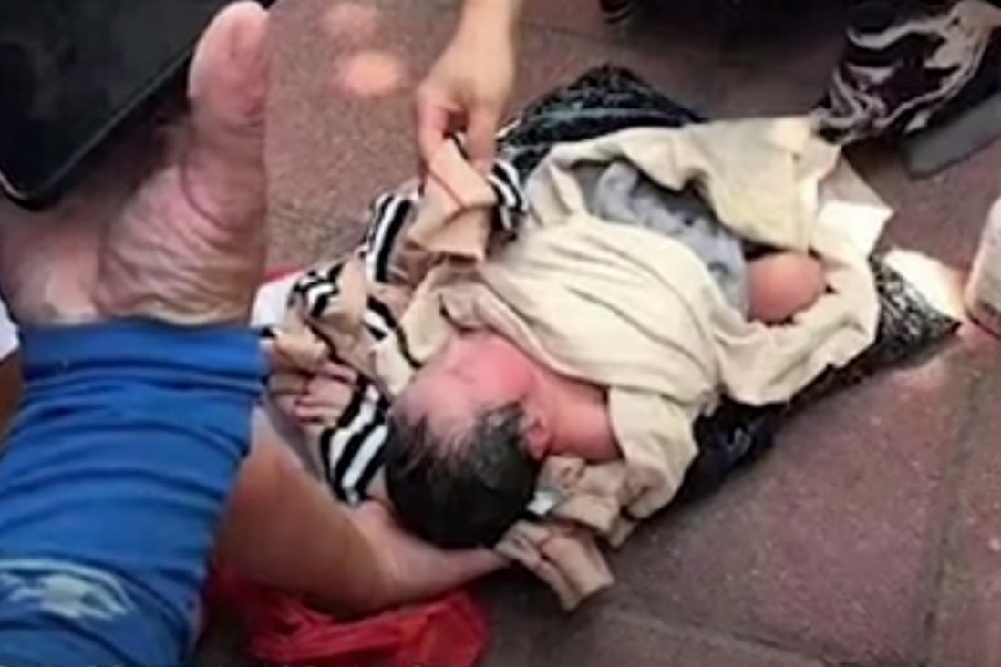 The baby girl lying on the street after the courier found her wrapped in bags. Photo: Handout
