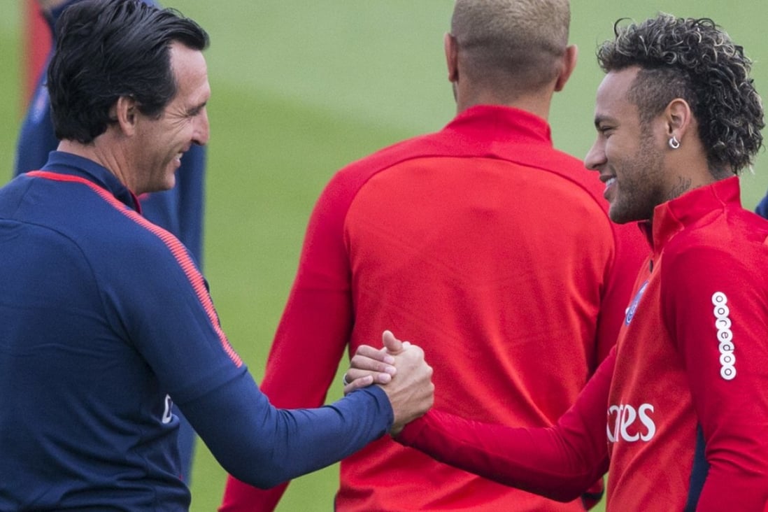 Paris Saint-Germain coach Unai Emery (left) greets Neymar during a training session at the Camp des Loges training centre in Paris. Photo: AP