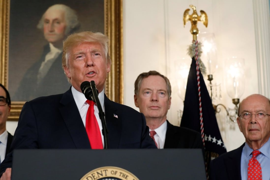 US President Donald Trump, flanked by Treasury Secretary Steven Mnuchin, left, US Trade Representative Robert Lighthizer, second from right, and Commerce Secretary Wilbur Ross, right, speaks before signing a memorandum directing the US Trade Representative to complete a review of trade issues with China. Photo: Reuters