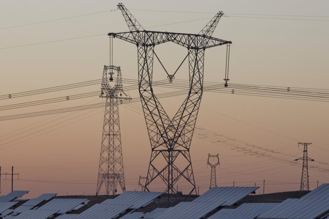 A file picture of electricity pylons and solar panels in northern China. Photo: Associated Press