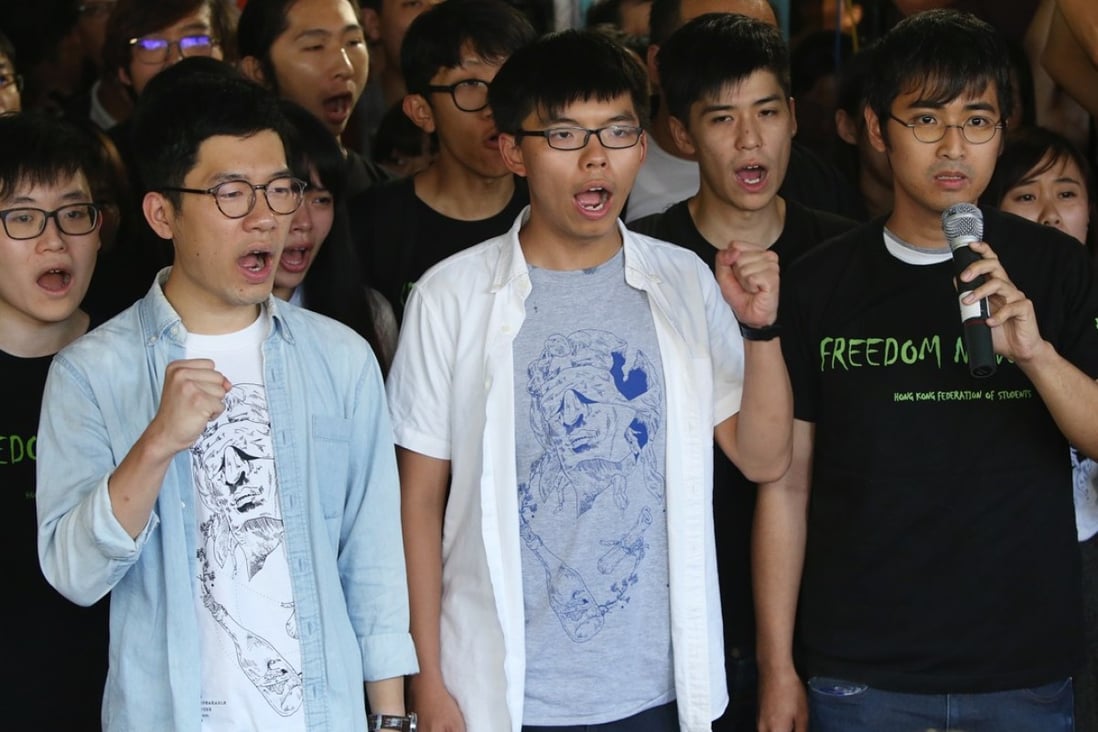 Nathan Law (left), Joshua Wong and Alex Chow protest outside the High Court. Photo: Sam Tsang