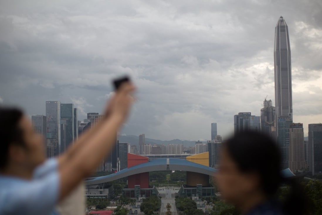 The Greater Bay Area encompasses 11 cities covering a 56,500 square kilometre. A couple take selfies overlooking Shenzhen’s business district. Photo: EPA
