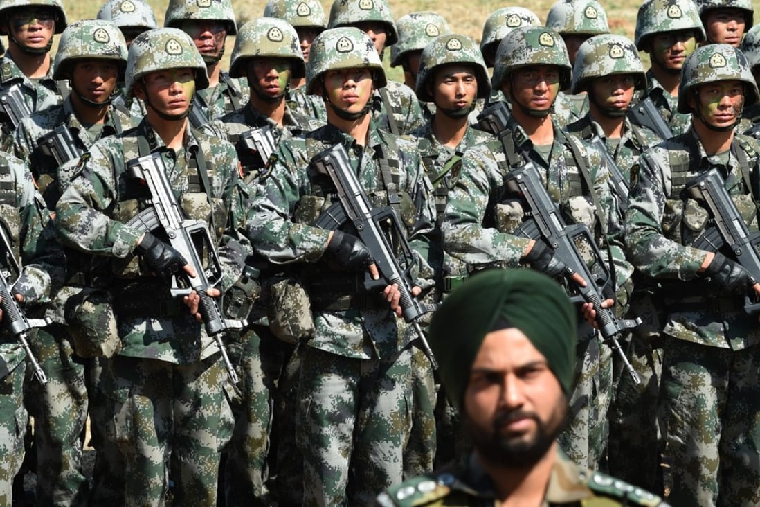An Indian Army soldier stands in front of a group of People’s Liberation Army (PLA) soldiers as they line up after participating in an anti-terror drill. Photo: AFP