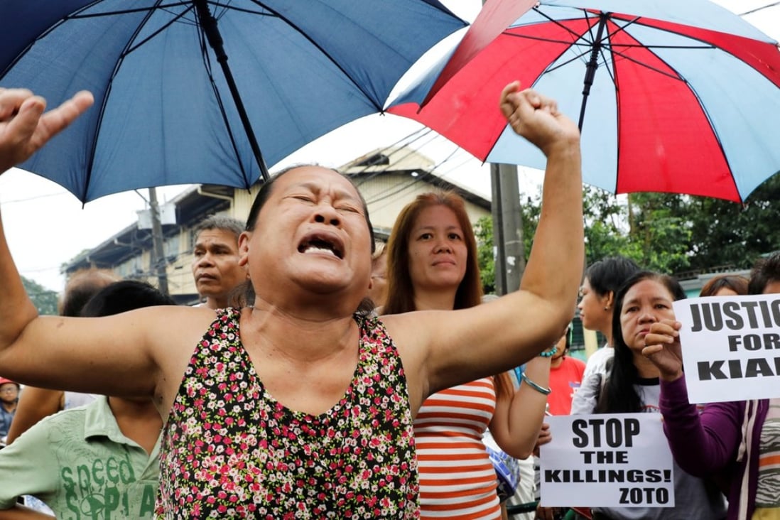A woman, whose son was also shot in a drug-related killing, cries during the funeral march of Kian Loyd Delos Santos. Photo: Reuters