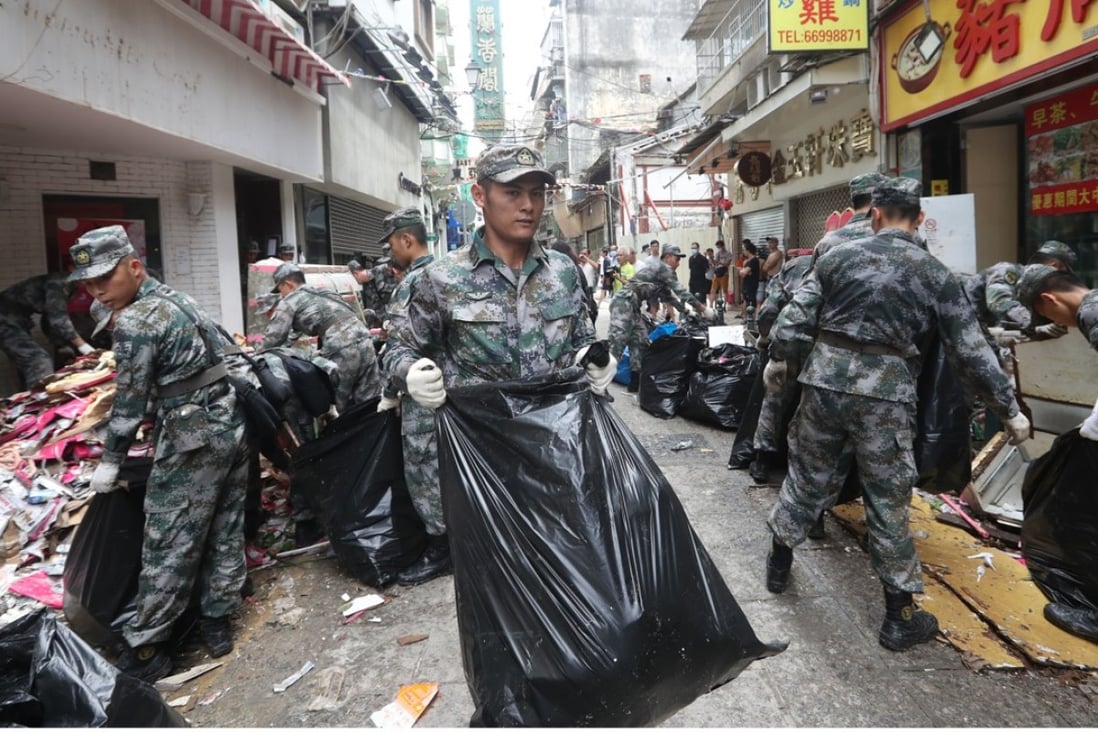 The Chinese Army helps Macau residents with the recovery effort after Typhoon Hato hit the city. Photo: Edward Wong