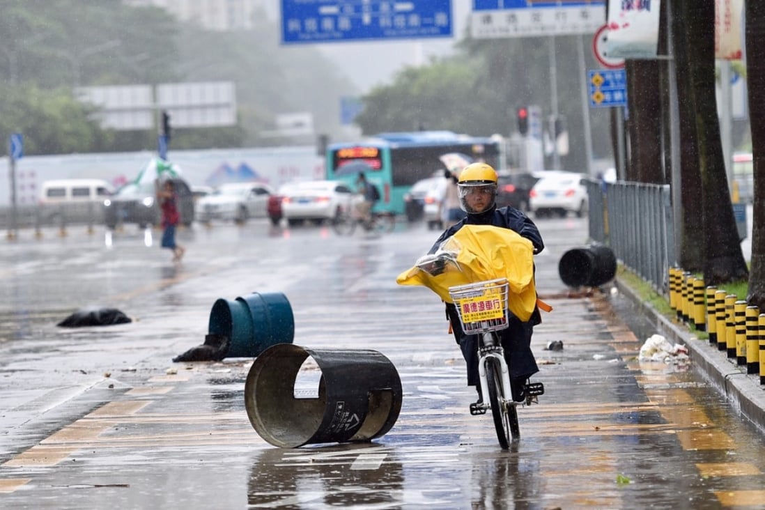 A food delivery worker rides against the rain in Shenzhen, south China, during Typhoon Hato. Photo: Xinhua