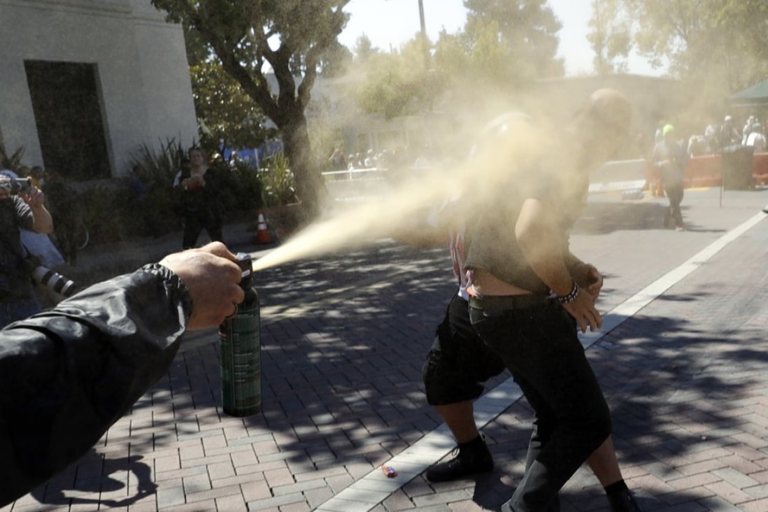 Joey Gibson, the leader of the Patriot Prayer group (right), is blasted with pepper spray in Berkeley, California, on Sunday. Photo: AP