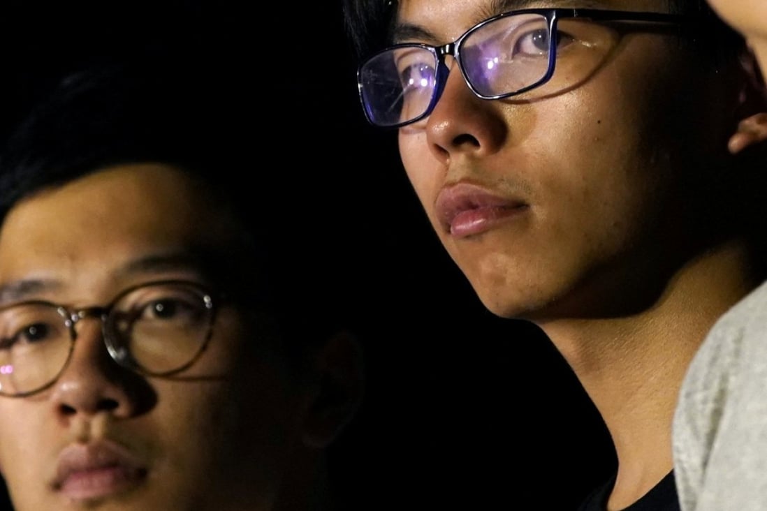Nathan Law (left) and Joshua Wong (centre) attend a rally on August 16, a day before an appeals court jailed them, and a third student leader Alex Chow (not pictured), for their involvement in an Occupy-related protest in 2014. Photo: Reuters