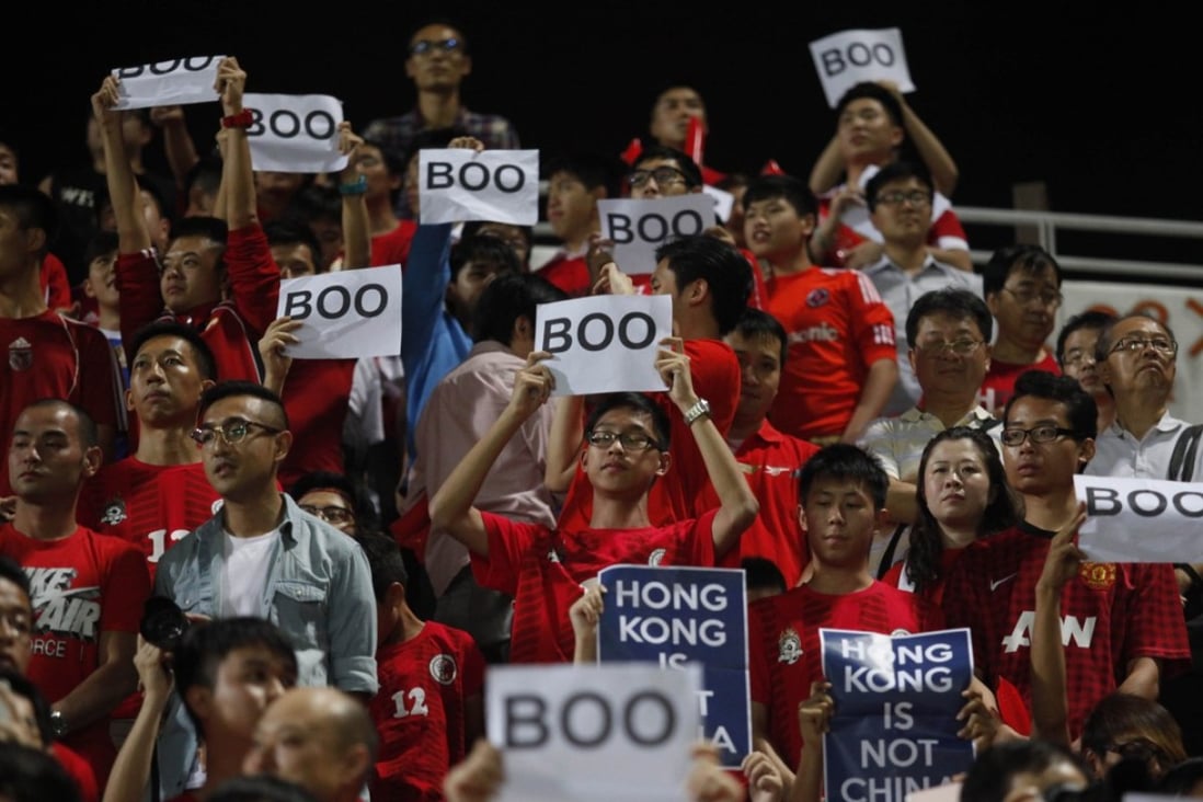 Hong Kong fans hold up signs that read “Boo” while the national anthem was being played back in 2015. More ‘creative’ responses to the new national anthem law are likely next October. Photo: AFP PHOTO