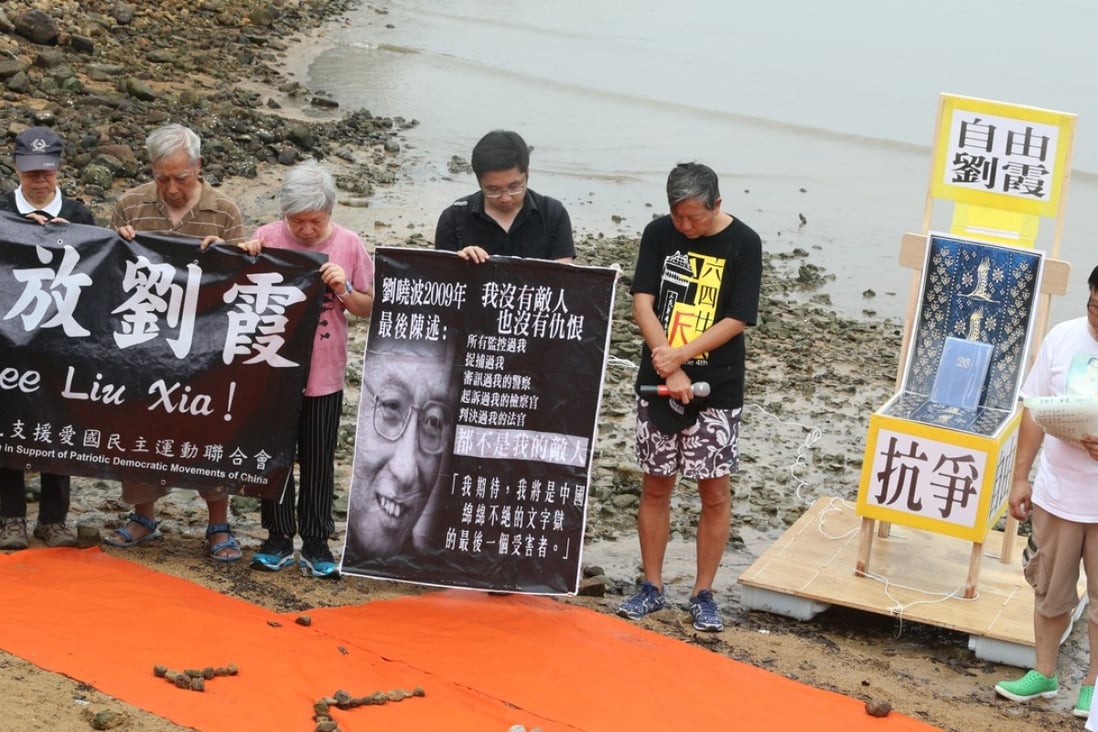 Members of the Hong Kong Alliance in Support of Patriotic Democratic Movements of China hold a memorial service by the sea in Sai Kung to commemorate Noble Laureate Liu Xiaobo. Photo: David Wong