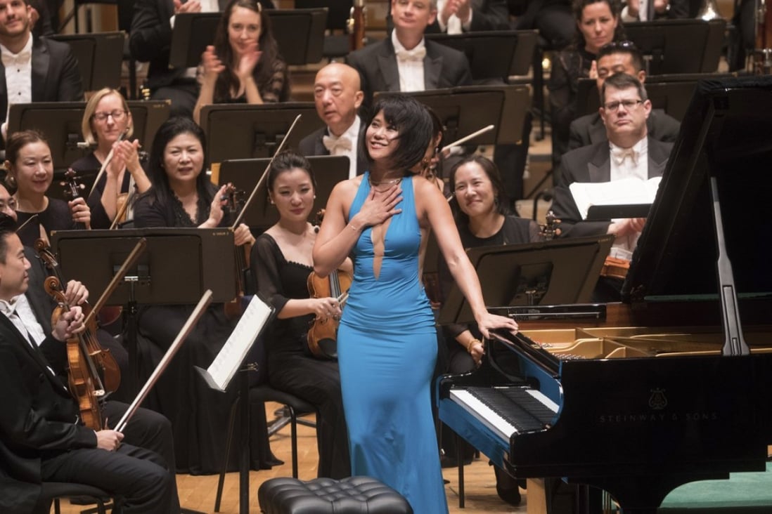 Yuja Wang receives applause for her performance of Tchaikovsky’s Piano Concerto No. 1 with the Hong Kong Philharmonic Orchestra on Friday. On Wednesday she plays chamber music with orchestra players including concertmaster Jing Wang (front, left). Photo: Cheung Wai-lok