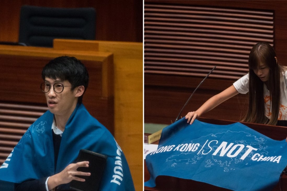 Sixtus Baggio Leung (L) and Yau Wai-ching (R) with flags that read "Hong Kong is not China" as they take their respective Legislative Council Oaths at the first meeting of the Sixth Legislative Council in Hong Kong. Photo: AFP