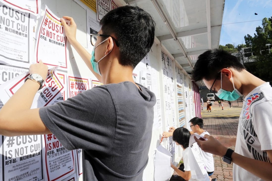 Chinese students put posters up on the “Wall of democracy” at Chinese University. Photo: Dickson Lee