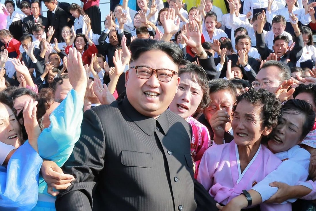North Korean leader Kim Jong-un poses in Pyongyang with teachers who volunteered to work on islands, and in frontline and mountainous areas. Photo: AFP/KCNA via KNS
