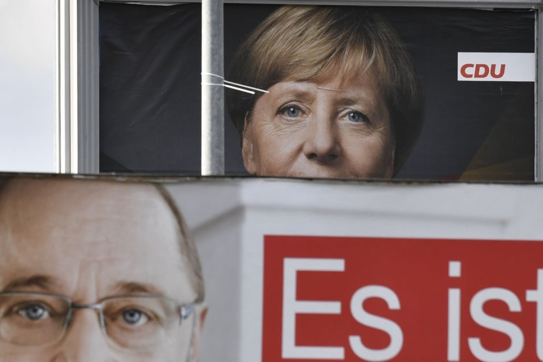 Billboards featuring Angela Merkel and Martin Schulz. Photo: AFP