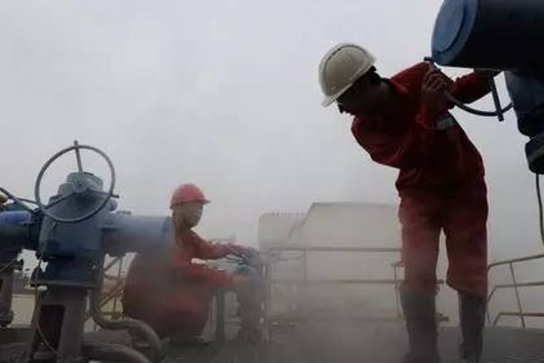 Chinese workers examine an oil pipeline. Photo: Handout