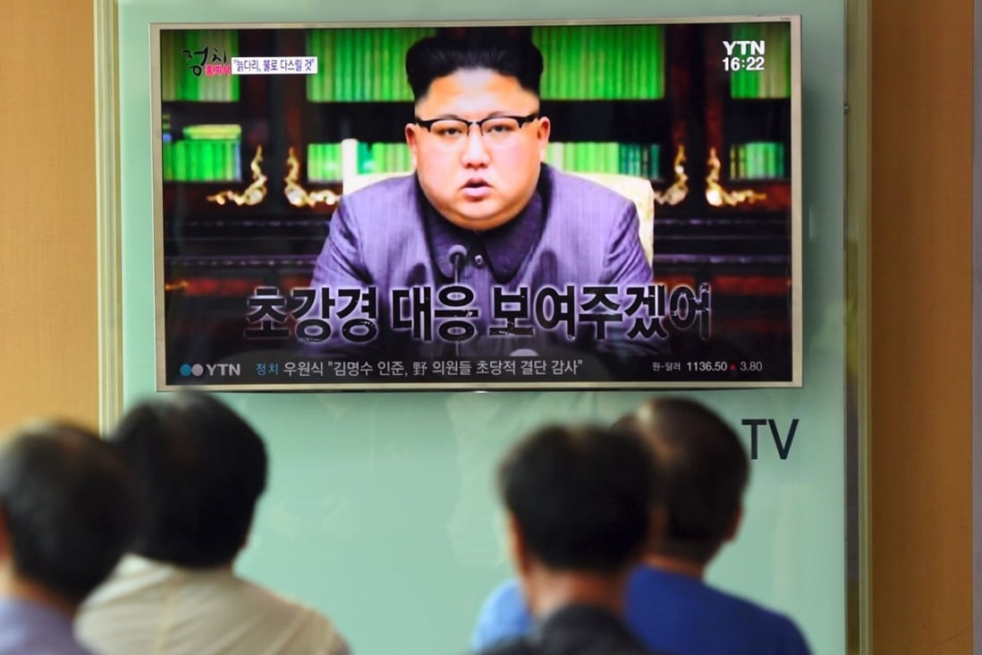People at a railway station in Seoul, South Korea, watch a television showing North Korean leader Kim Jong-un delivering a statement in Pyongyang on Friday. The same day China urged all parties to avoid imposing unilateral sanctions against the restive state. Photo: AFP