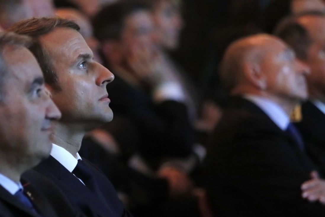 French President Emmanuel Macron (second left) and President of the Protestant Federation of France, Pastor Francois Clavairoly look on during a ceremony to mark the 500th anniversary of Protestant Reform on Friday at the Hotel de Ville in Paris. Photo: AFP