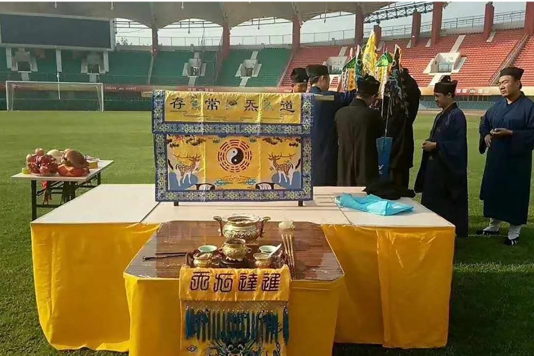 Taoist priests perform a religious ritual on the pitch at Hanghai Stadium, the home field of Chinese Super League side Henan Jianye, in Zhengzhou. Photo: AFP