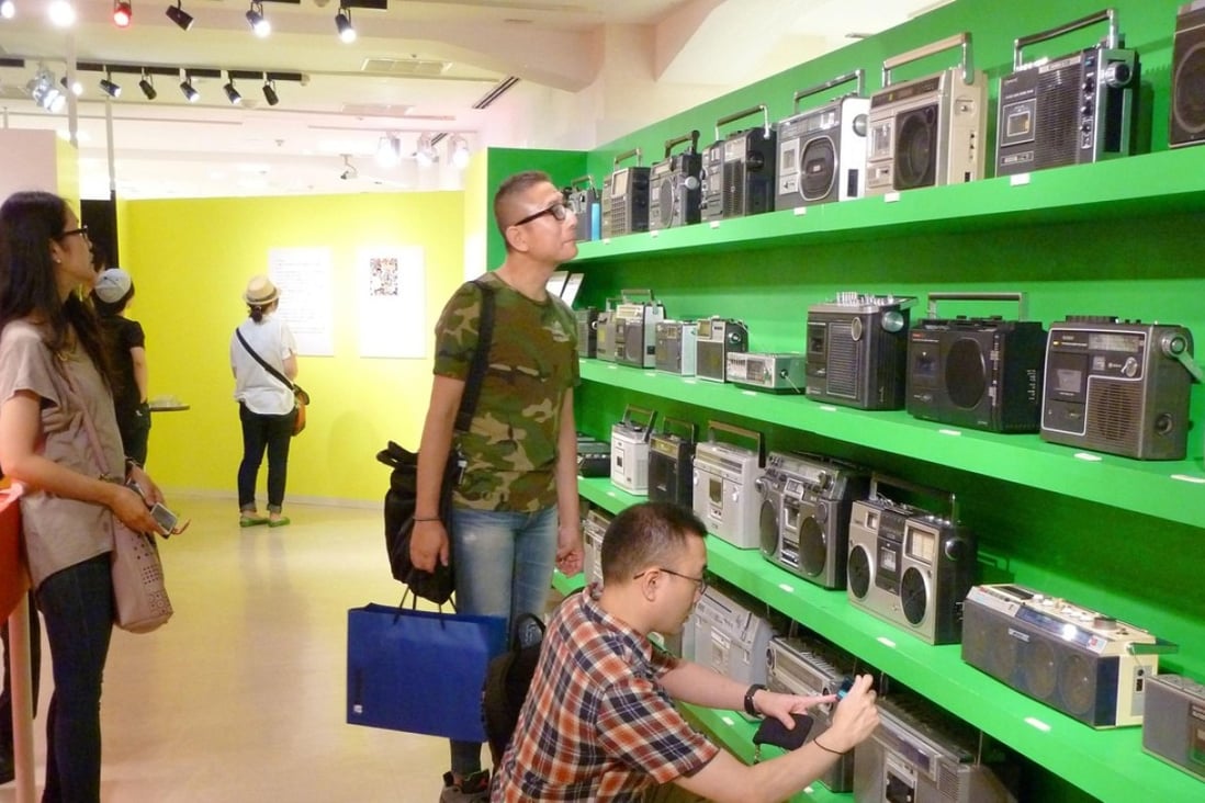 Visitors check out radio-cassette players at an exhibition in the Seibu department store in Tokyo's Shibuya district in August. Along with vinyl's resurgence, the boom box is experiencing a revival. Photo: Kyodo