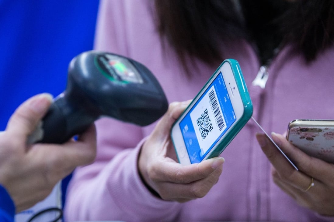 A customer uses a QR code on a mobile phone to make a payment. Photo: ImagineChina