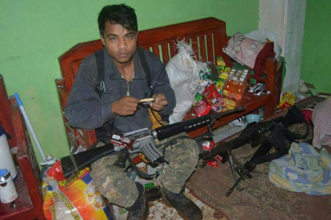 A member of the militant Maute group is seen inside a house in Marawi in July, two months after the Islamic State-affiliated group seized the city. Photo: AFP