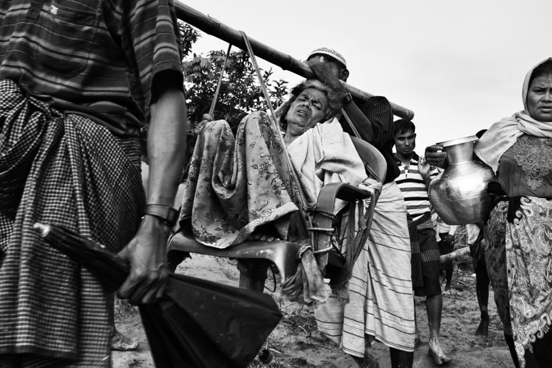 A Rohingya woman is carried by family members in the Balukhali refugee camp on September 20. Picture: Greg Constantine