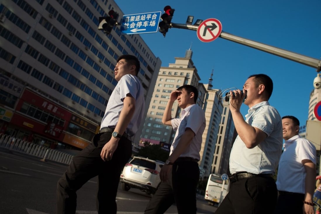 People cross a road in Shenyang, Liaoning province. In a recent survey, 56 per cent of EU companies said they would be interested to invest more in China if wider market access were granted. Photo: AFP