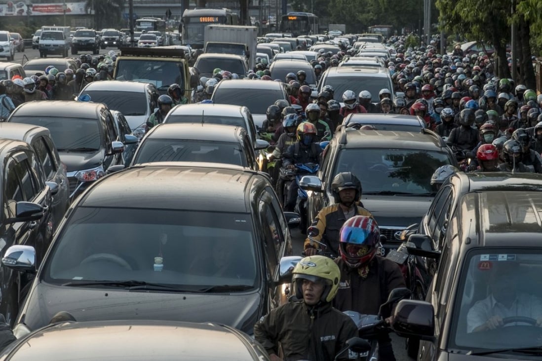 Commuters wait in a traffic jam during afternoon rush hour in Jakarta, Indonesia. Photo; AFP