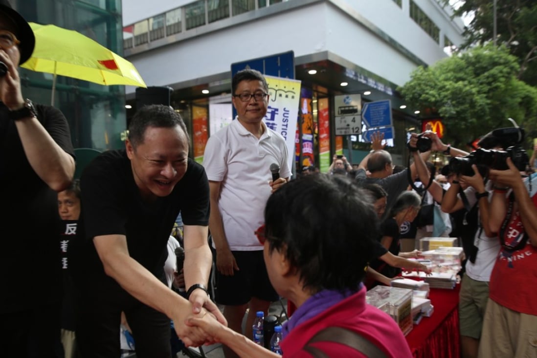 Independence activist Benny Tai Yiu-ting shakes hands with a supporter during a rally in Hong Kong on October 1 with the aim of rejecting “authoritarian rule” and to demand the resignation of Hong Kong’s Secretary for Justice Rimsky Yuen Kwok-keung. Photo: Sam Tsang