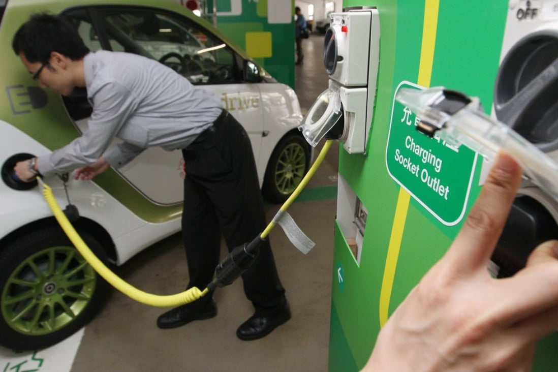 Officials show how to charge electric vehicles at the opening ceremony of the government's publicity campaign on electric vehicles and charging points in Central, in May 2012. Photo: Felix Wong