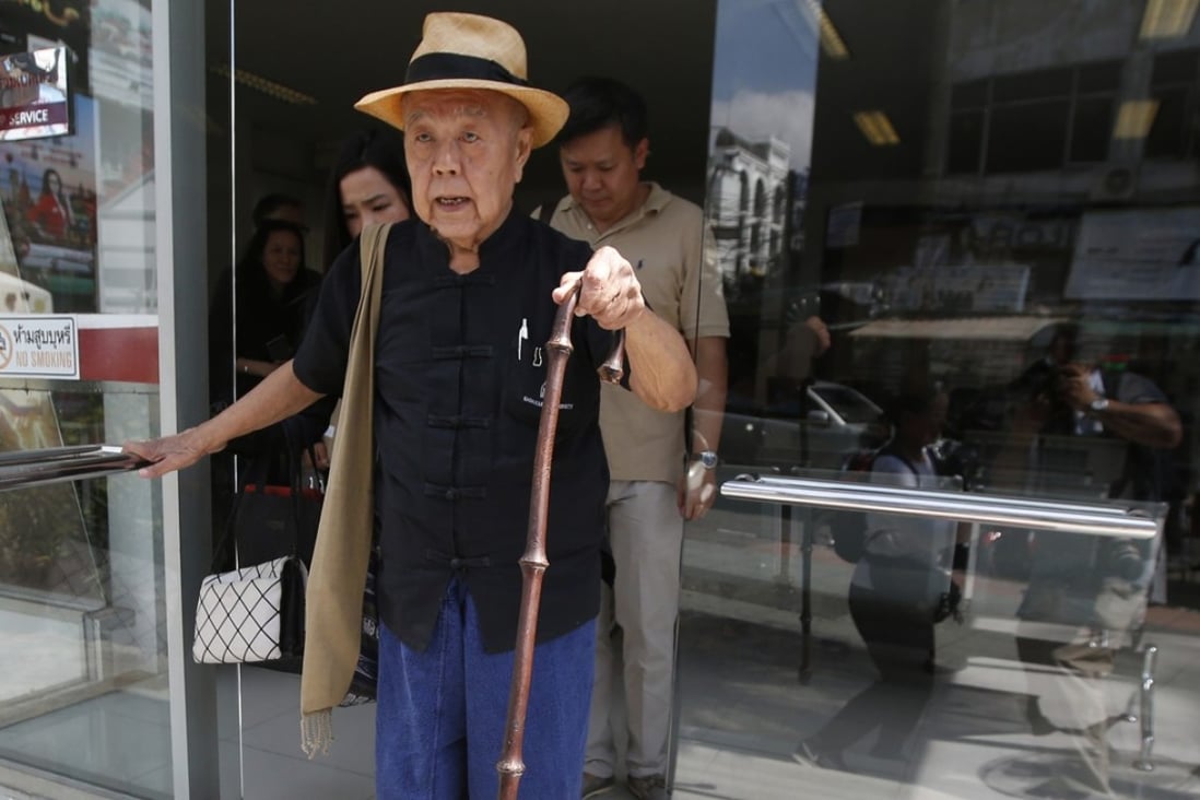 Thai social critic Sulak Sivaraksa leaves a police station to go to a military court. Photo: AP