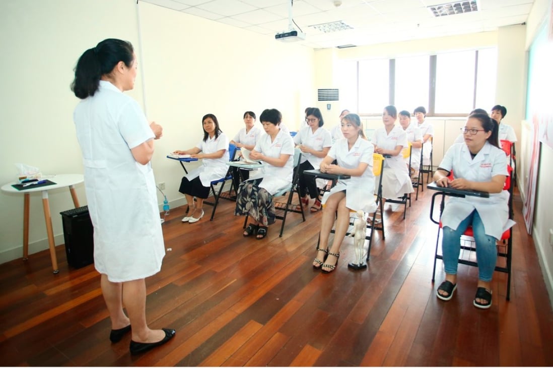 Students take a class on stimulating breast milk secretion in Duole, a Shanghai-based training centre for domestic helpers. Photo: Handout