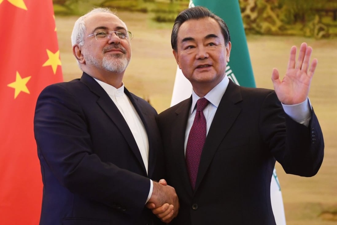 Iranian Foreign Minister Mohammad Javad Zarif (left) shakes hands with Chinese Foreign Minister Wang Yi after a joint media briefing in 2016. China and Iran have close economic, trade and energy ties. Photo: EPA