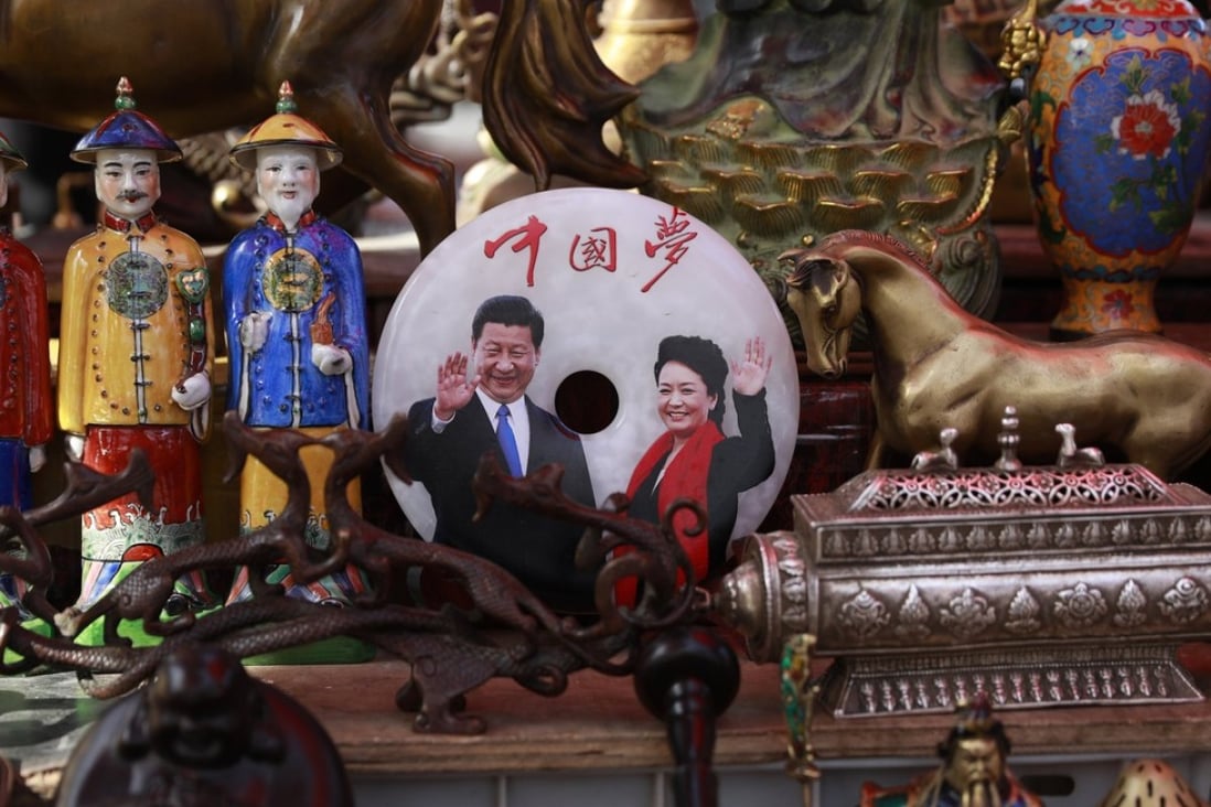 A jade plaque with a picture of Chinese President Xi Jinping and his wife Peng Liyuan below the words ‘China Dream’. Photo: EPA