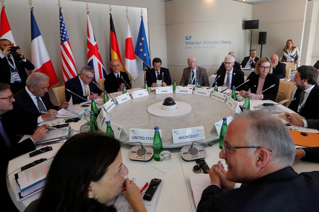 Interior Ministers sit around the table during a G7 Interior Ministers meeting with representatives from the world’s biggest tech firms. Photo: Reuters