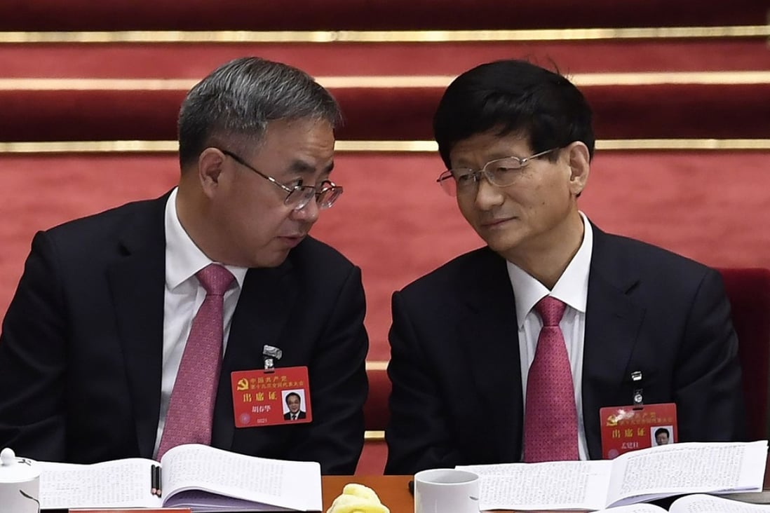 Guangdong party secretary Hu Chunhua (left) chats with fellow Politburo member Meng Jianzhu at the opening session of the Communist Party's national congress at the Great Hall of the People in Beijing on Wednesday. Photo: AFP