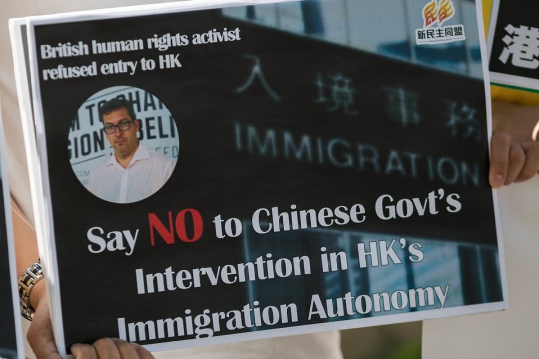 A placard at a protest outside Hong Kong government offices. Benedict Rogers was barred from the city on October 11. Photo: EPA