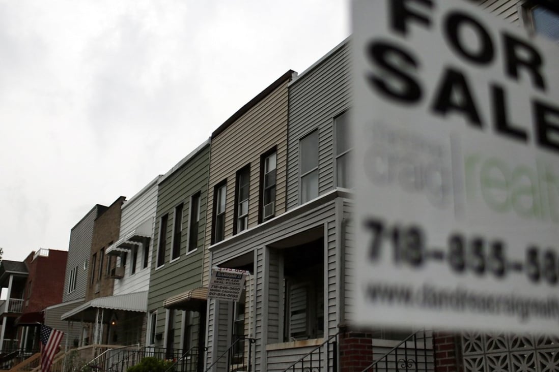 A “For Sale” sign hangs outside a home in New York’s Brooklyn area. According to a triennial study by the Federal Reserve called Survey of Consumer Finances, the average American family's net worth dropped almost 40 per cent between 2007 and 2010, mainly as a result of crashing real estate prices. Photo: AFP