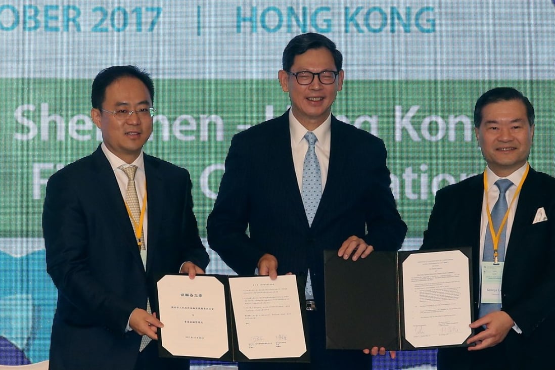 (L to R) Director-General, Office of Financial Development Service (Shenzhen) Xiaojun He; Chief Executive of the Hong Kong Monetary Authority (HKMA), Norman Chan Tak-lam and Chairman of Hong Kong Cyberport Management Dr. George Lam attend HKMA collaboration signing at Hong Kong Fintech Day, Hong Kong Convention and Exhibition Centre (HKCEC) in Wan Chai. Photo: SCMP / David Wong