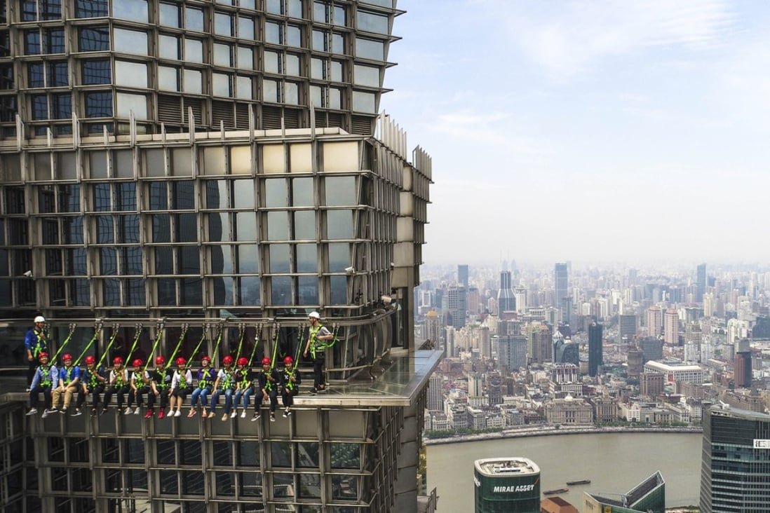 Tourists on a skywalk at Jinmao Tower in Shanghai. Photo: Xinhua
