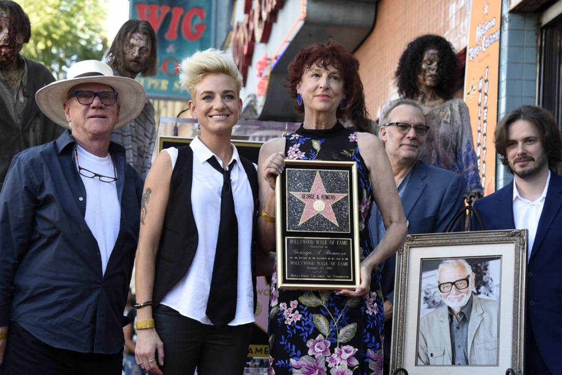 Suzanne Desrocher, centre, the widow of the late director George A. Romero, is joined by actor Malcolm McDowell, foreground from left, Romero's daughter Tina, special effects/make-up artist Greg Nicotero and director Edgar Wright during a ceremony awarding Romero with a star on the Hollywood Walk of Fame on Wednesday, October 25, 2017, in Los Angeles. Romero is the writer/director of the 1968 zombie film “Night of the Living Dead.” Photo: Invision/AP