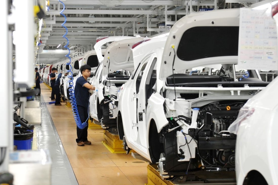 Workers on a car production line in Cangzhou in Hebei province. Photo: Xinhua