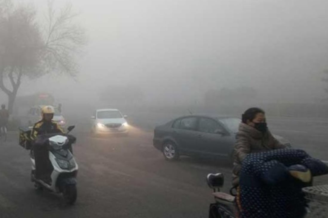 Road users make their way through heavy smog in Beijing on Friday morning. Photo: Handout