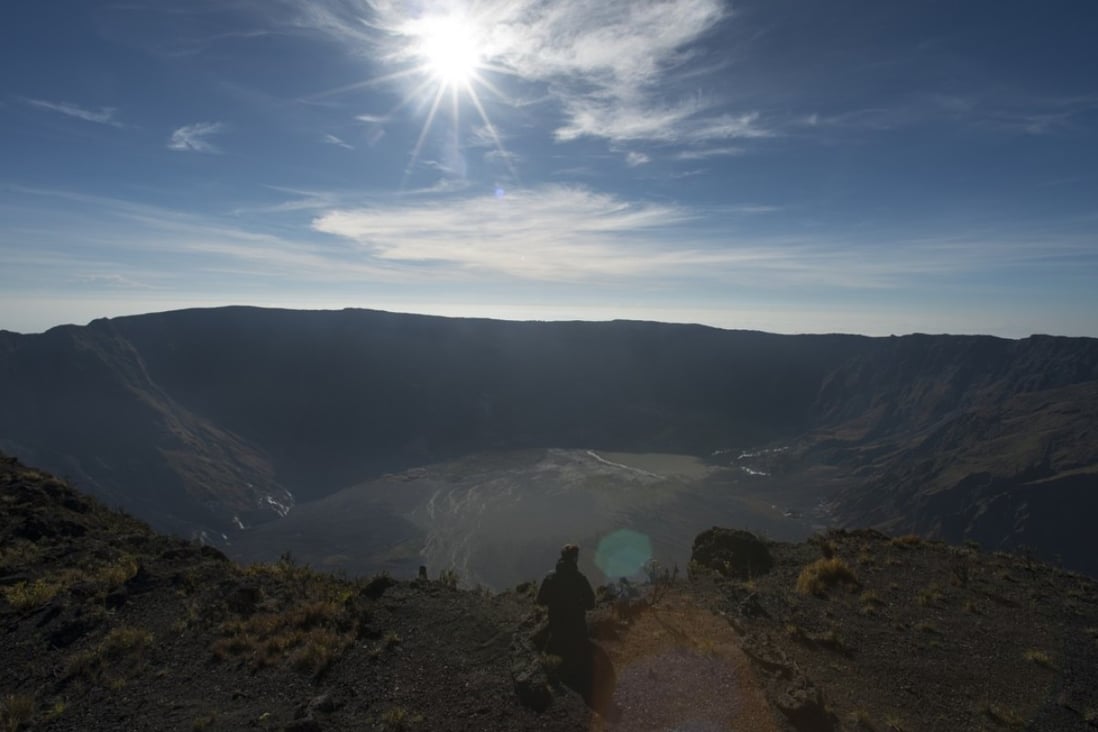 Peter Day sits at the crater’s edge, on Mount Tambora, on the Indonesian island of Sumbawa. Pictures: Antony Dickson