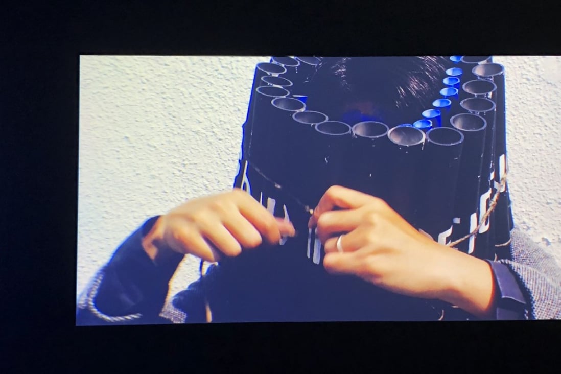 In Kwan Sheung-chi’s video work Before the End: Pierrot le Fou (1965), the artist is seen tying dynamite around his head before lighting the fuse. Photo: Enid Tsui