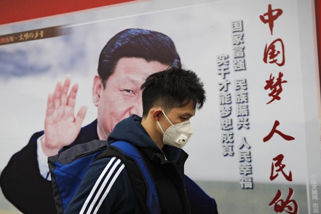 A man wearing a mask for protection against pollution walks by a poster featuring President Xi Jinping, in Beijing on October 26. Xi, considered China’s most powerful and influential leader in decades, has made environmental clean-up and sustainability central to his agenda. Photo: AP