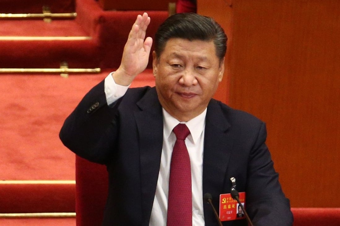 Chinese President and General Secretary of the Communist Party of China Xi Jinping raises hand to take a vote during the closing ceremony of the 19th National Congress of the Communist Party of China. Photo: EPA